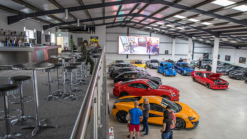 2024-11-15 Los Angeles USA A vast underground car collection at Petersen Automotive Museum's Vault, featuring rare classic, exotic, and concept cars in a dimly lit garage.